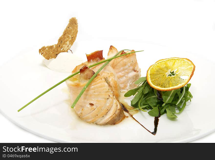 Fried fish with greens and rolls on a plate. Fried fish with greens and rolls on a plate