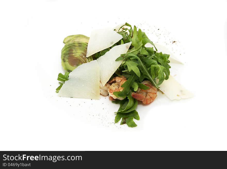 Shrimp with arugula on a plate on a white background