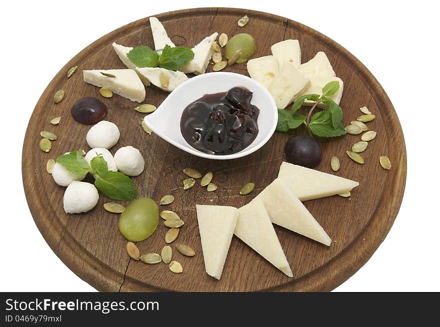 Wooden plate with cheeses