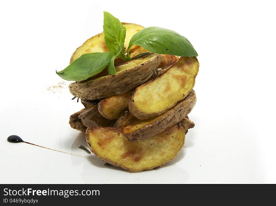 Baked potatoes on a plate decorated with greens