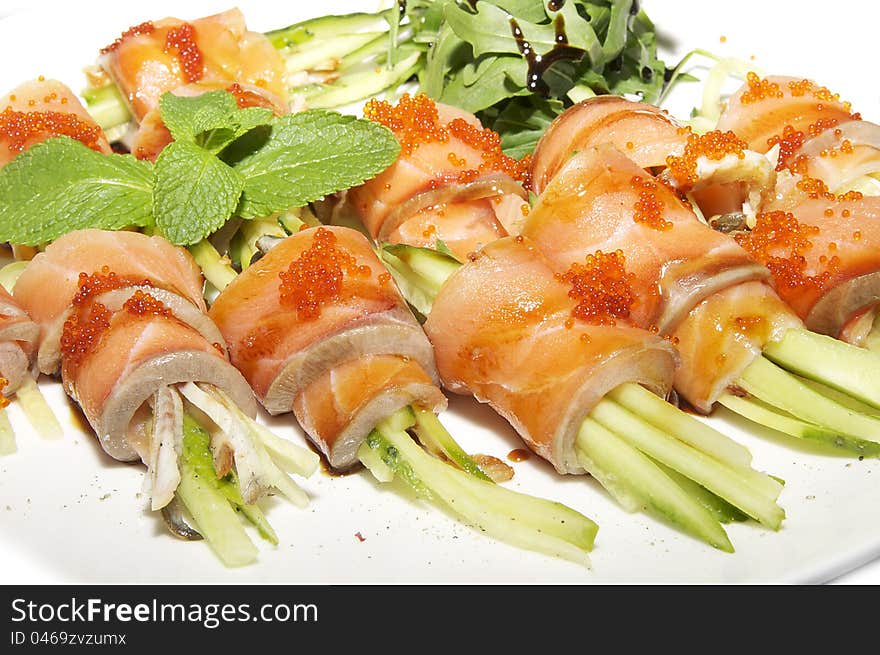 Fish rolls with herbs on a white background