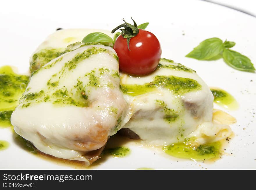 Meat cheese and tomato on a white plate. Meat cheese and tomato on a white plate