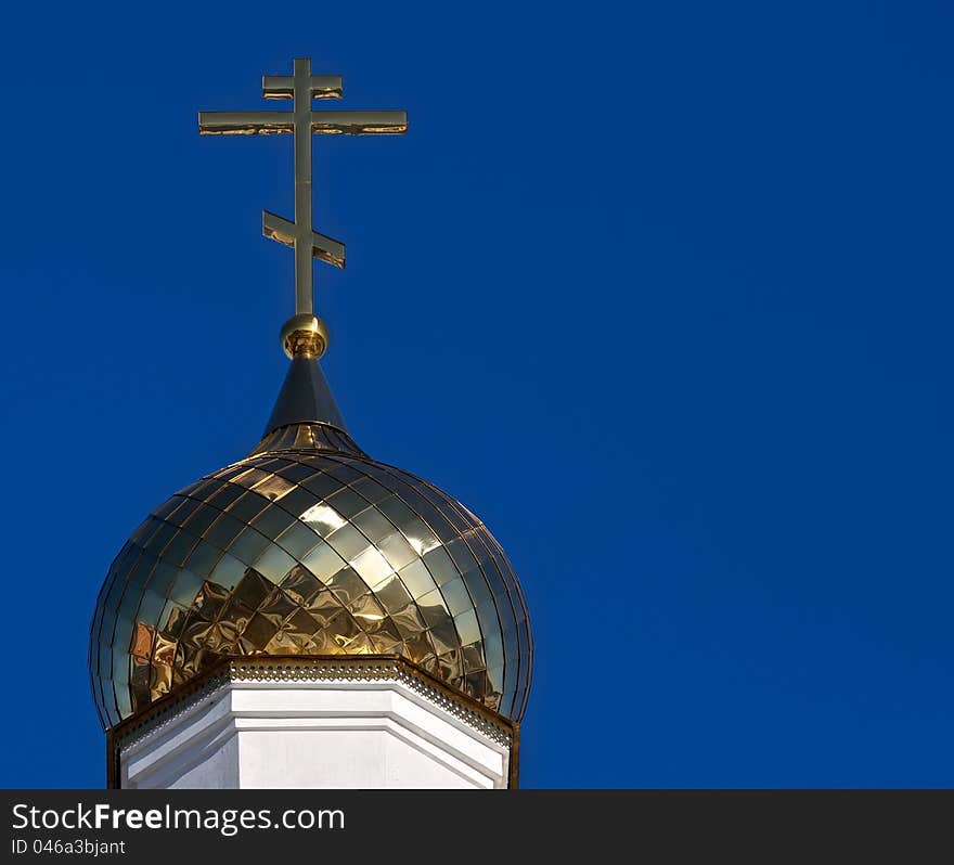 The golden dome gleams in the sun. He carries a gold cross, a symbol of the Christian Church. The golden dome gleams in the sun. He carries a gold cross, a symbol of the Christian Church.