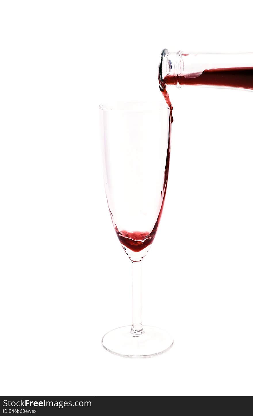 Red wine pouring in the glass from the bottle on white background. Red wine pouring in the glass from the bottle on white background