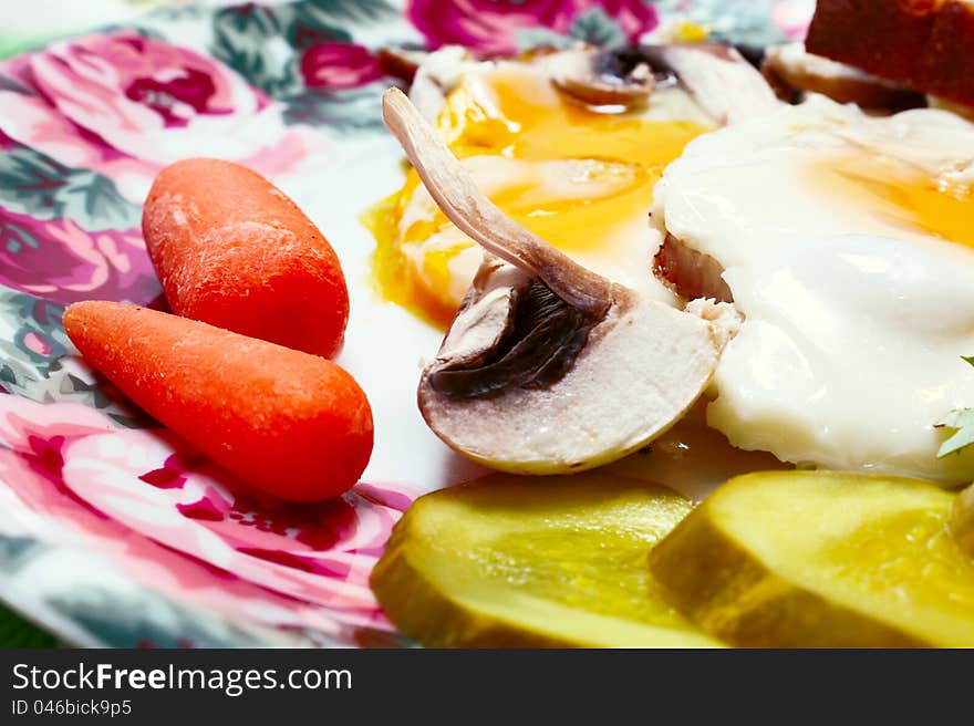 Fried eggs with fresh vegetables on plate