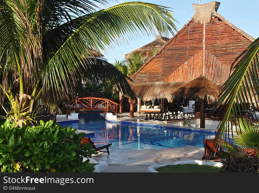 A tropical bar and pool area in a resort on the Riviera Maya. A tropical bar and pool area in a resort on the Riviera Maya