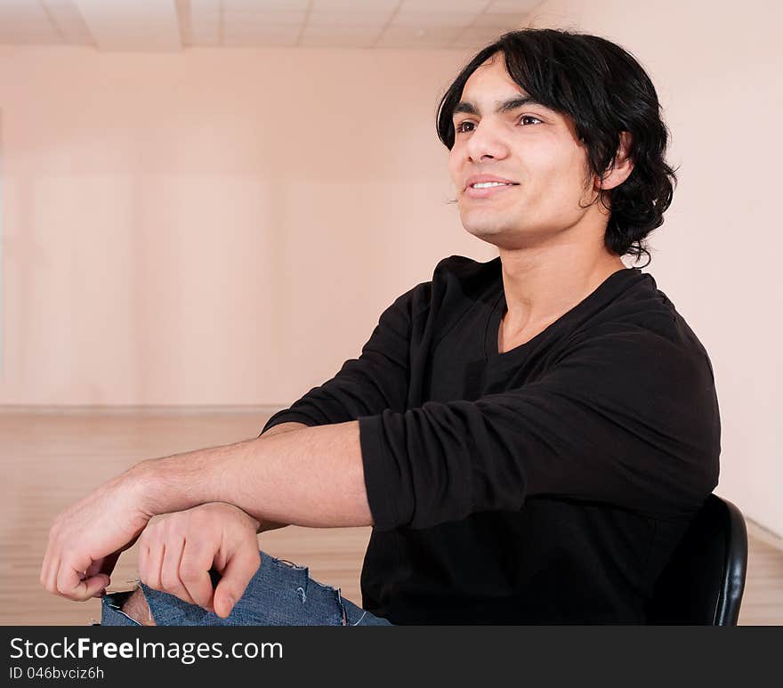 Young cheerful dancer man in training hall. Young cheerful dancer man in training hall