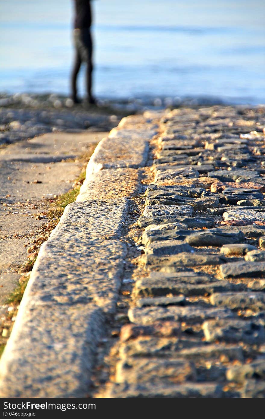 Tranquil photo of a cobbled path leading to the beach and sea. Tranquil photo of a cobbled path leading to the beach and sea.