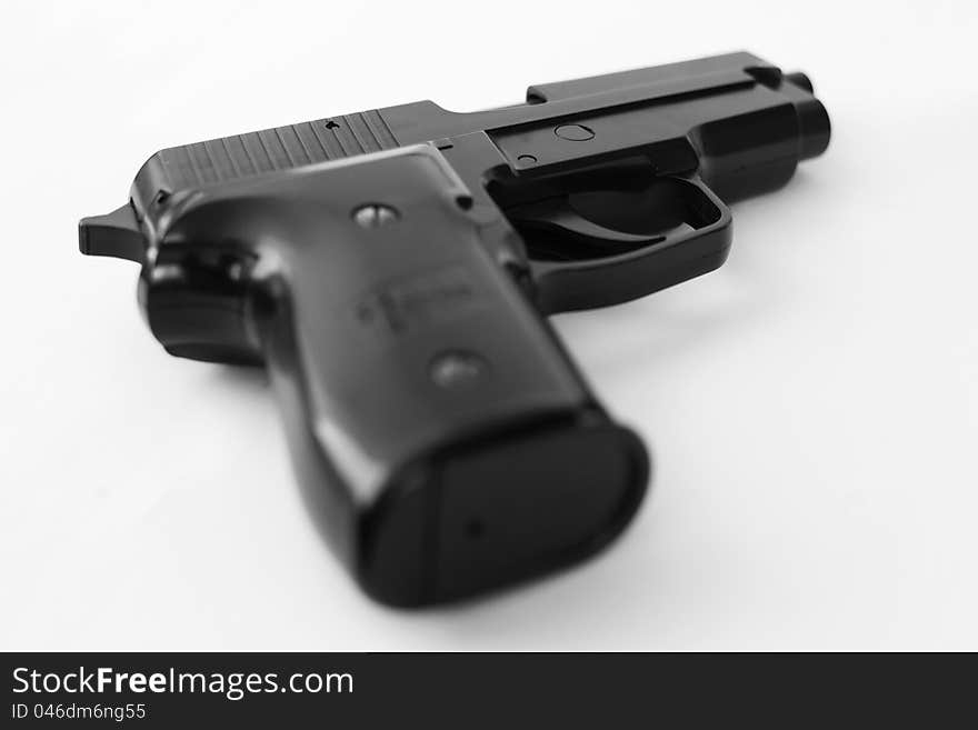 Black and white studio shot of a pistol on white background. Black and white studio shot of a pistol on white background