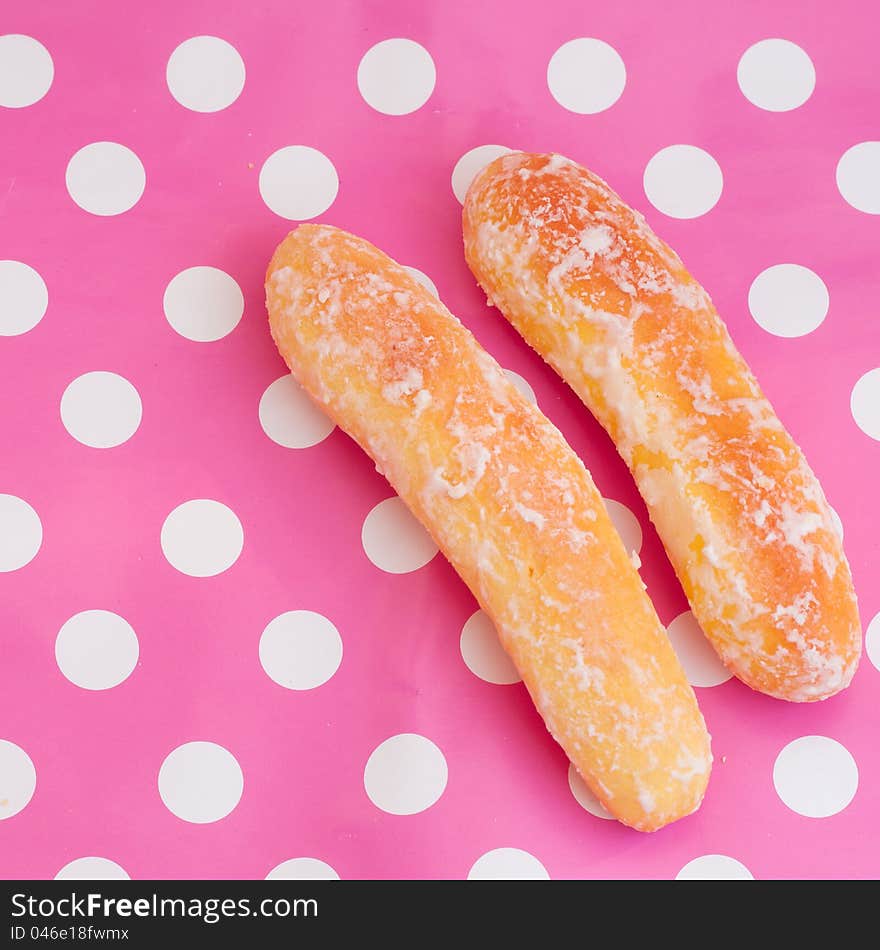 2 bread sticks on polka dot pink background. 2 bread sticks on polka dot pink background