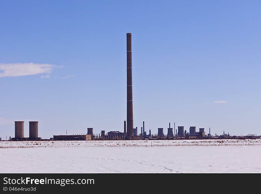 Industrial chimney in winter landscape