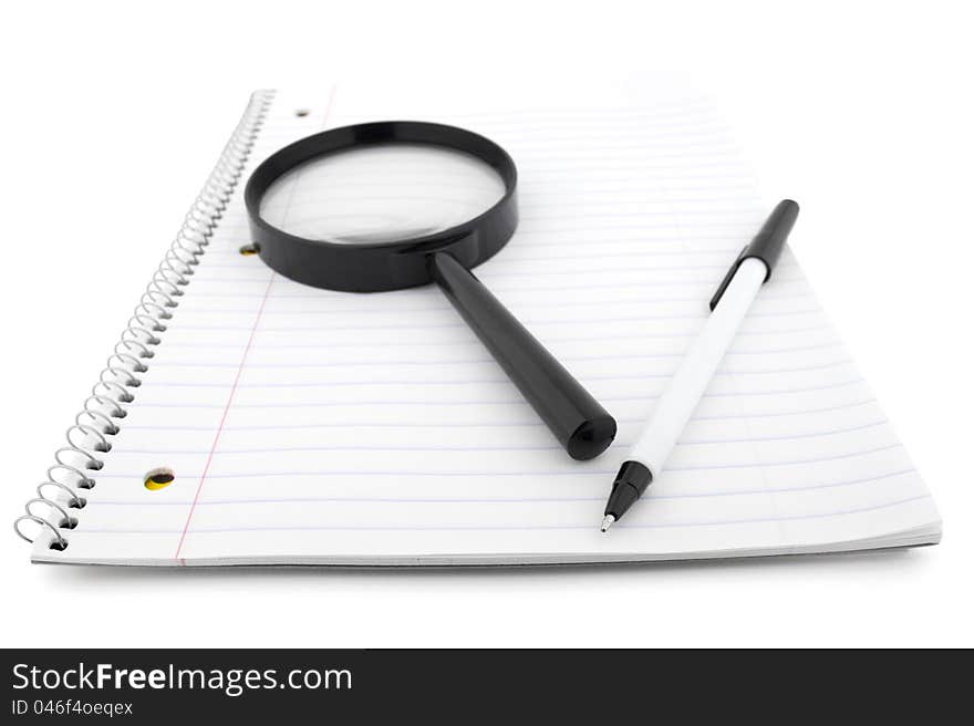 Open notepad with pen and lens  on white