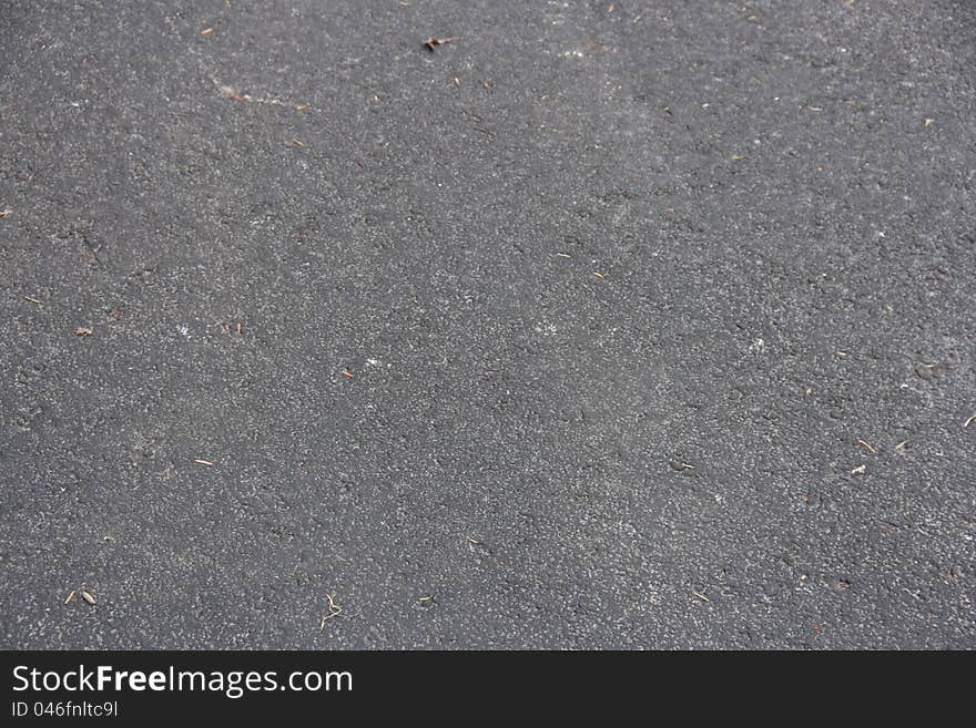 A close-up of a blacktop road surface. A close-up of a blacktop road surface.