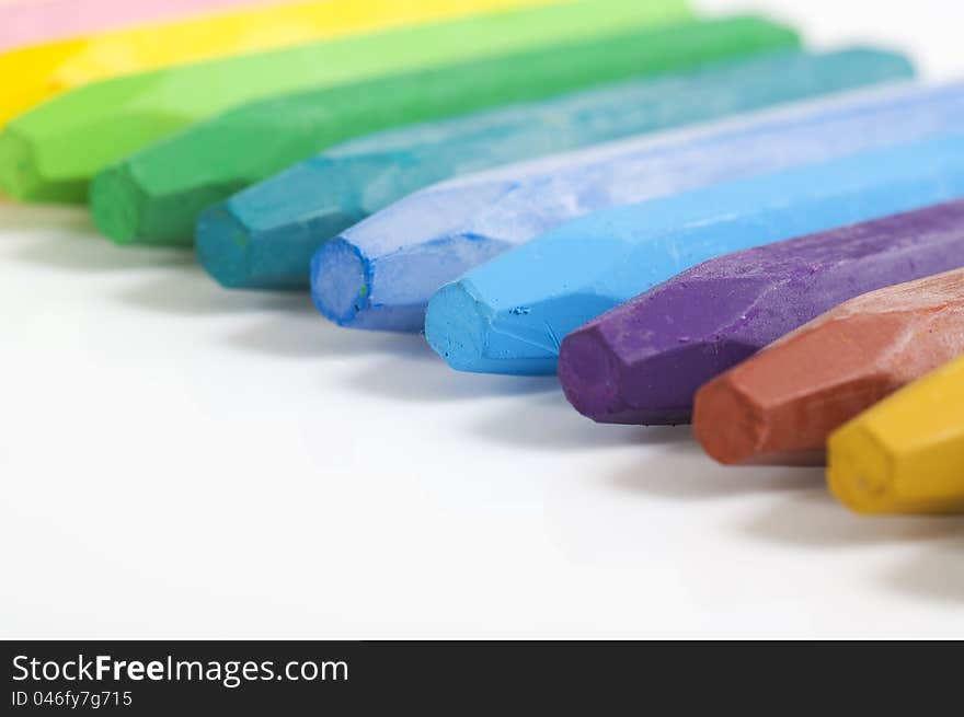 Group of crayons stacked on white background