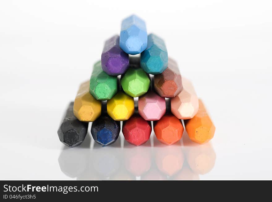 Group of crayons stacked on white background