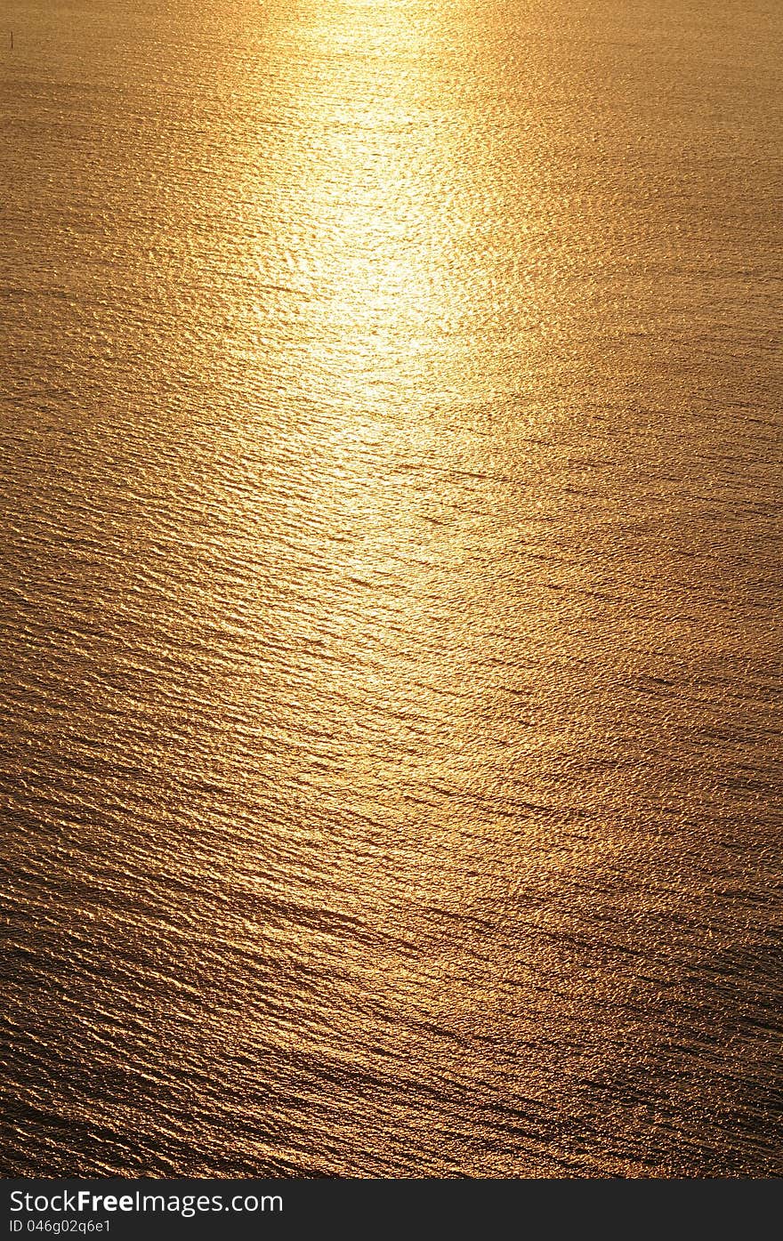 Sunset reflection on water with golden color. Sunset reflection on water with golden color.