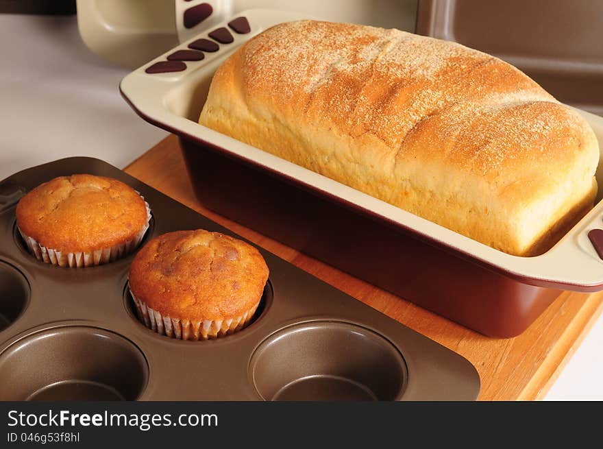 Sweet muffins and bread on kitchen counter. Sweet muffins and bread on kitchen counter.