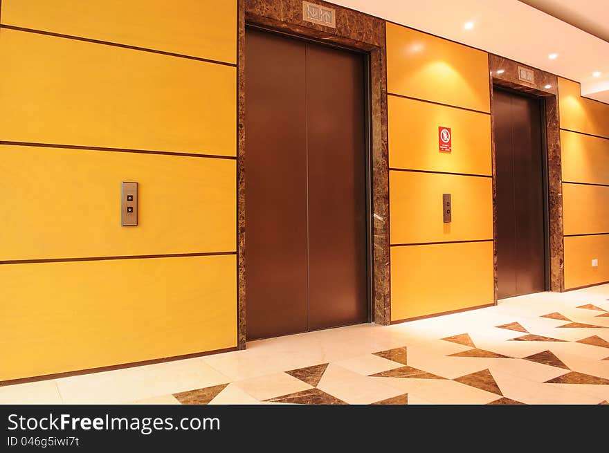 Hallway in a building interior with two elevators. Hallway in a building interior with two elevators.