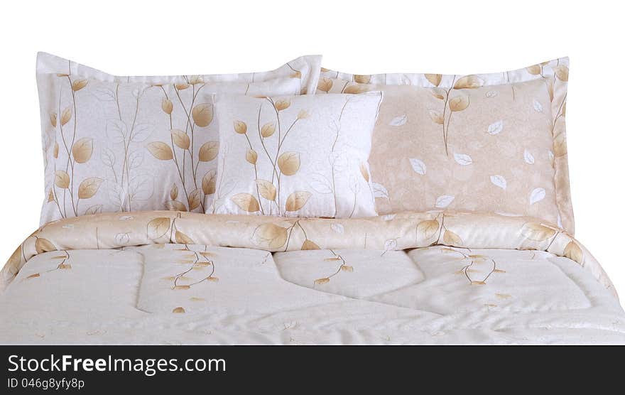 Soft pillows on bed spreads against white background. Soft pillows on bed spreads against white background.