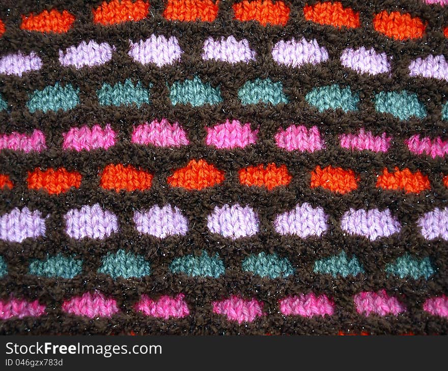 Multi-colored soft knitted fabric with a pattern. Textured background