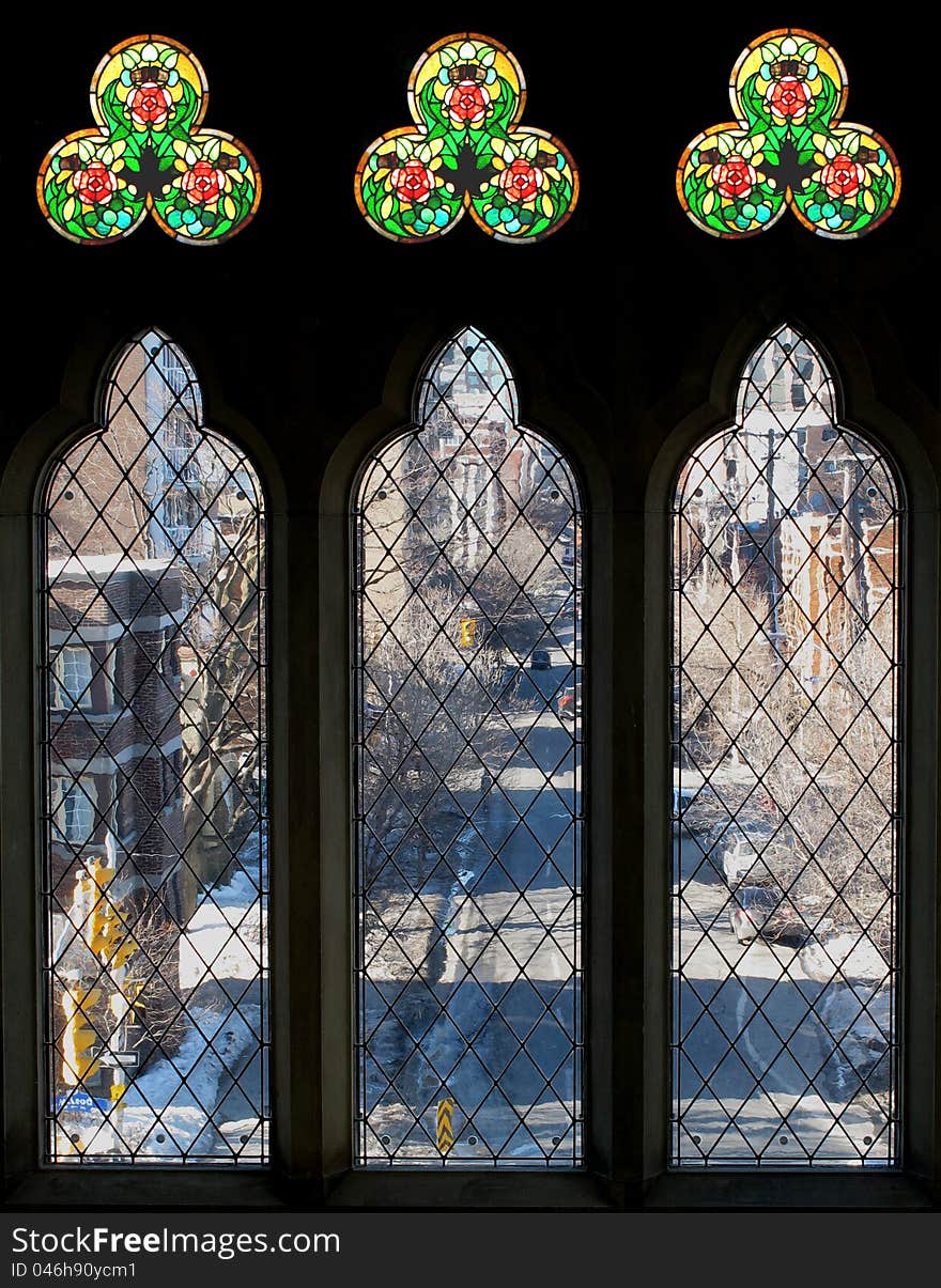 Three tall windows and stained glass