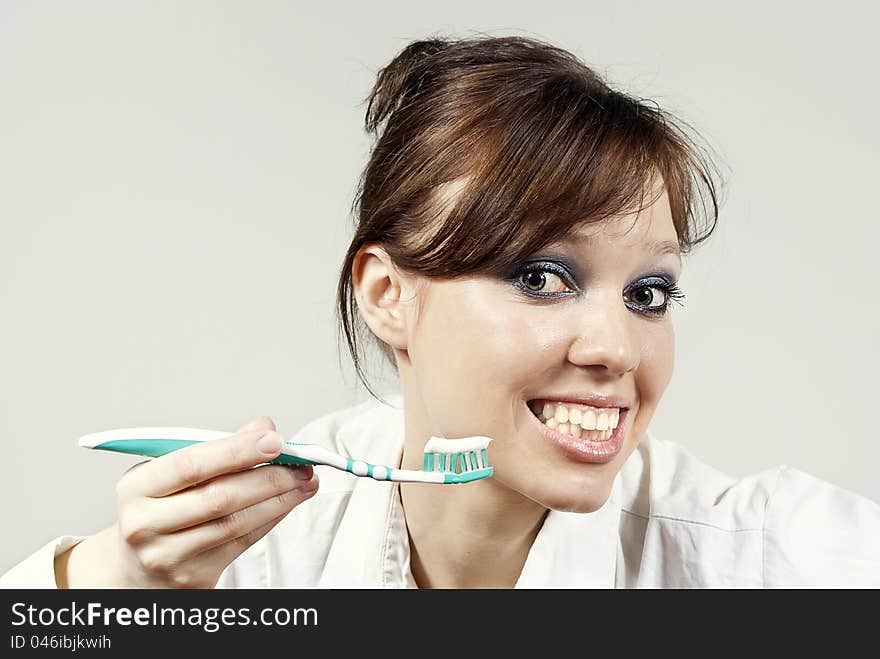 Girl keeps a toothbrush with toothpaste