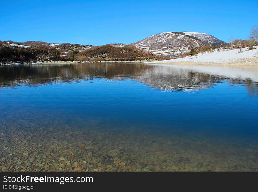 Mountain lake of Fiastra in the winter season - Marche (MC), Italy. Mountain lake of Fiastra in the winter season - Marche (MC), Italy.