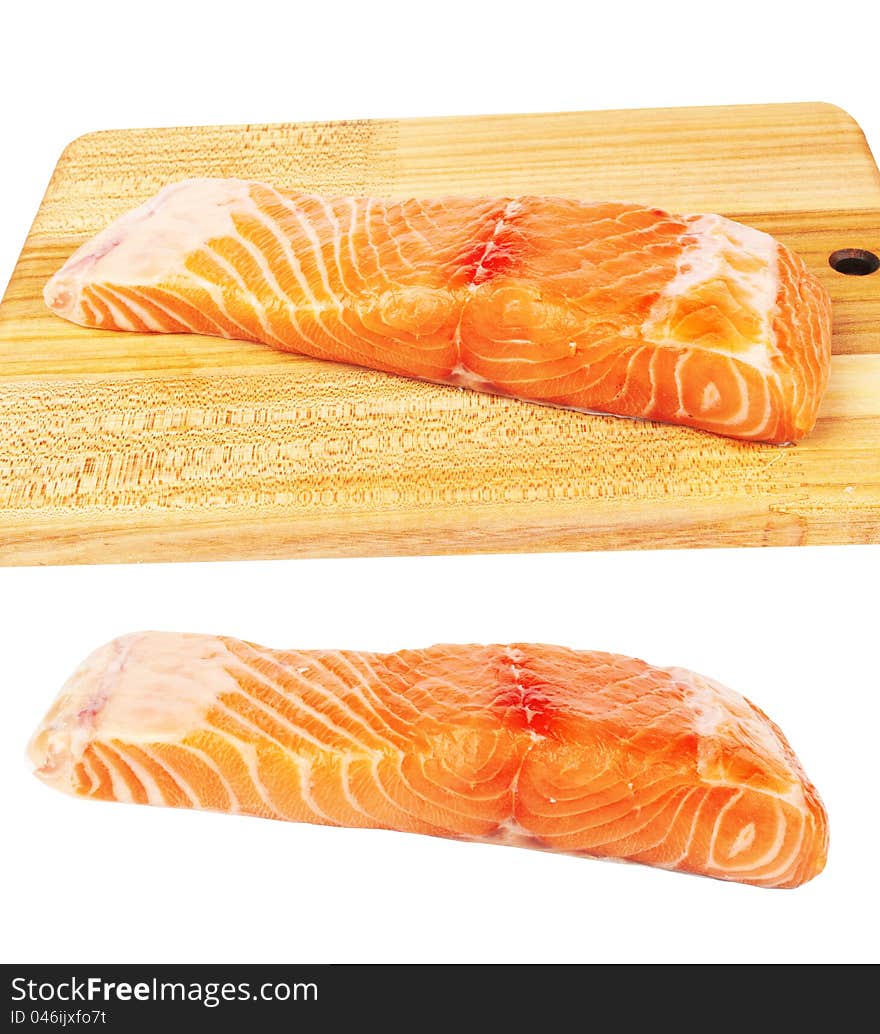 Fresh raw salmon fish piece over wooden board isolated on white background