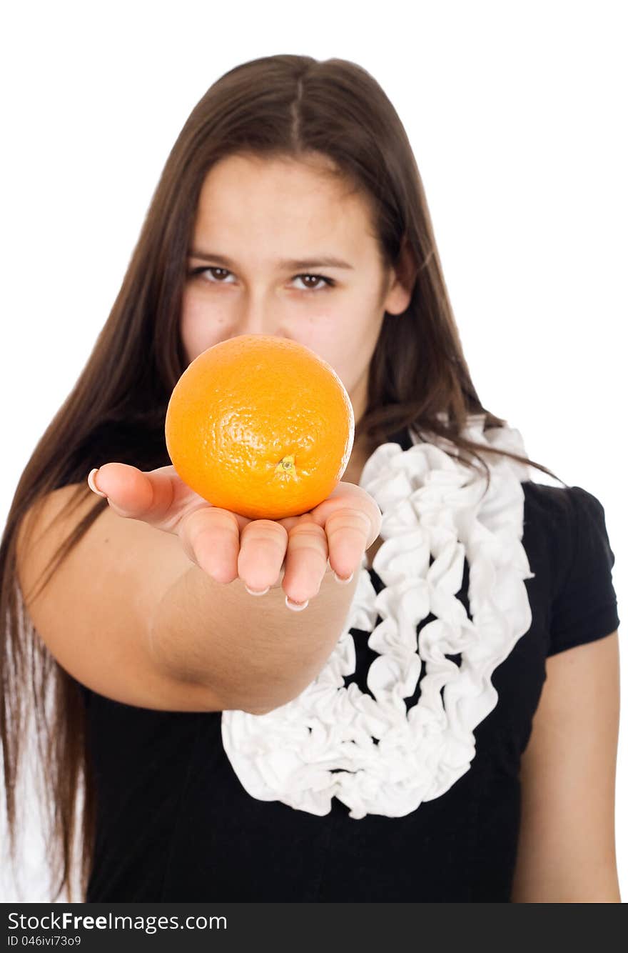 Beautiful girl holds out an orange. Beautiful girl holds out an orange