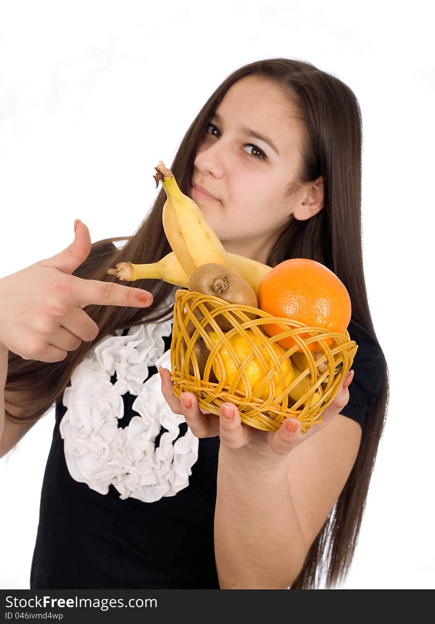 Girl holds out a basket of citrus fruit