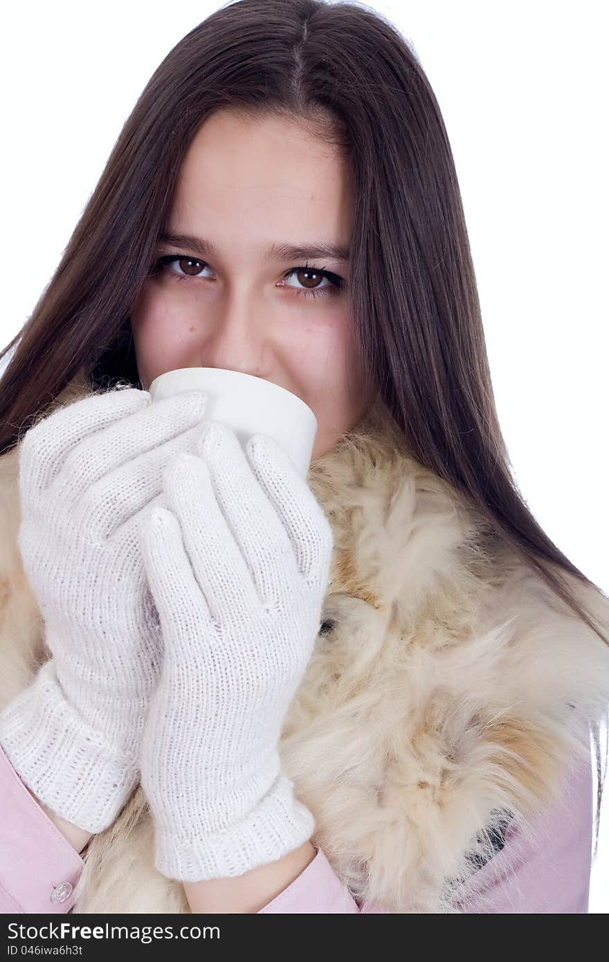 Woman in winter clothes and white gloves, drinking tea and warmed. Woman in winter clothes and white gloves, drinking tea and warmed