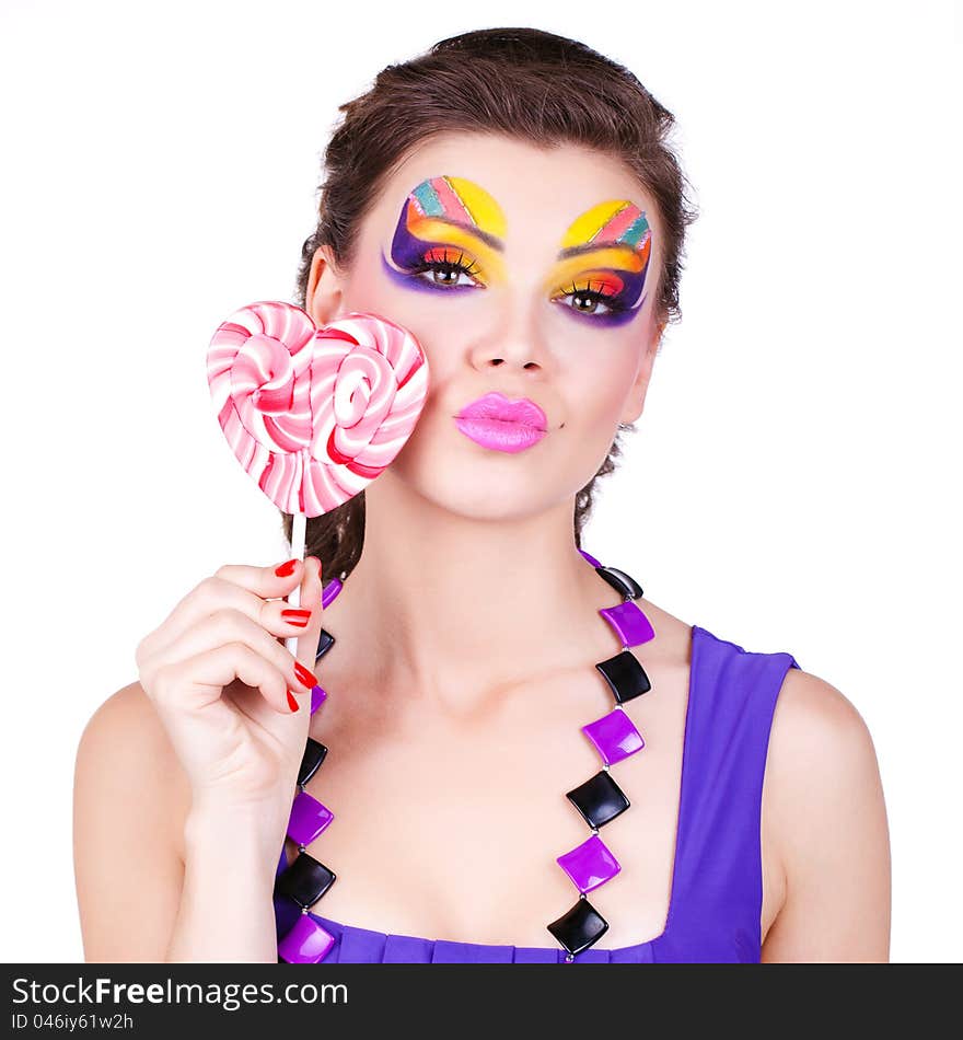 Glamourous beautiful woman holding lollipop