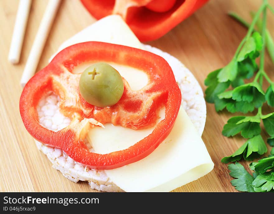 Raw red pepper, olive, light cheese and rice waffle for a healthy snack. Raw red pepper, olive, light cheese and rice waffle for a healthy snack.