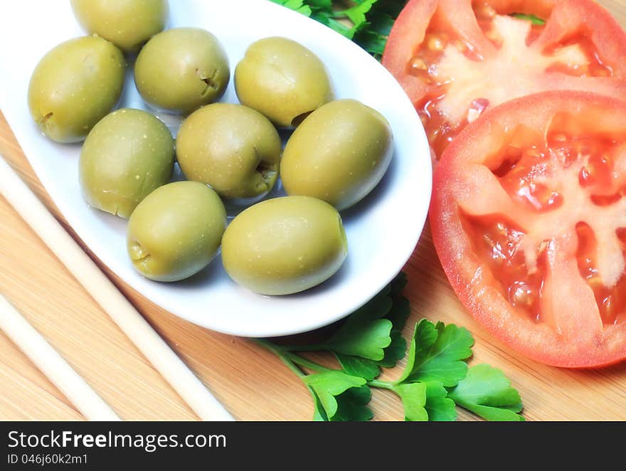 Green raw olives, tomato and parsley. Green raw olives, tomato and parsley.