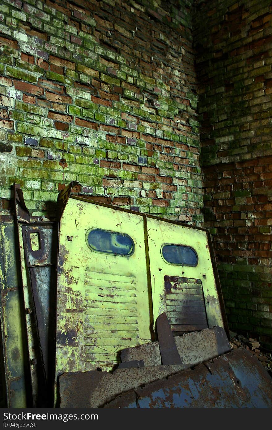 Old steel door leaning against a brick wall cracked. Old steel door leaning against a brick wall cracked