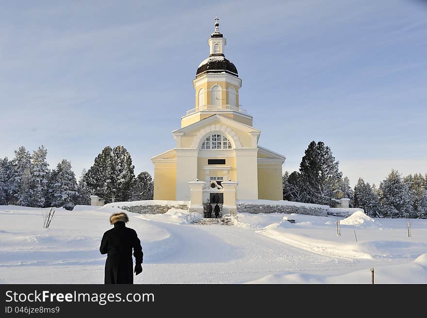 A man in a fine fur cap on his way to church. A man in a fine fur cap on his way to church