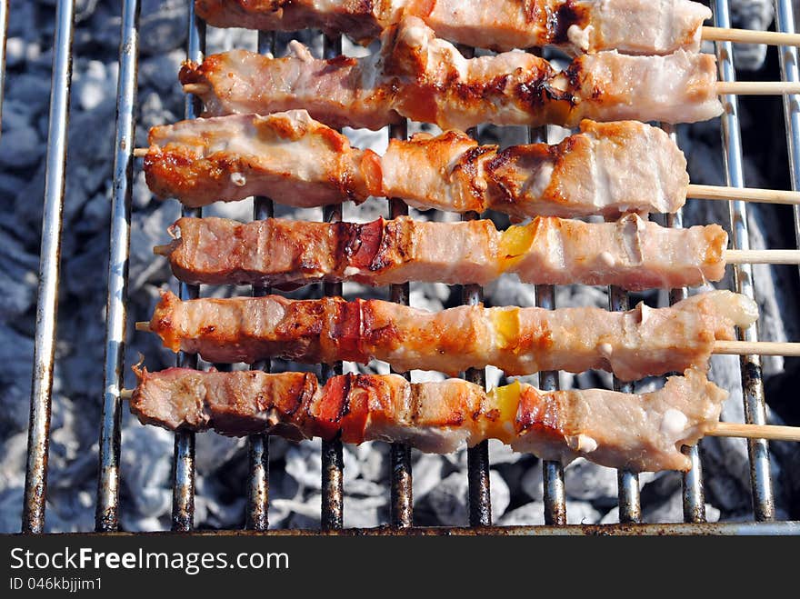 Cocked pork kabobs grilled on skewers on a barbecue