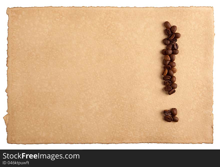 An exclamation mark symbol made from coffee crops on hand-made paper, isolated on white. Place for text. An exclamation mark symbol made from coffee crops on hand-made paper, isolated on white. Place for text.