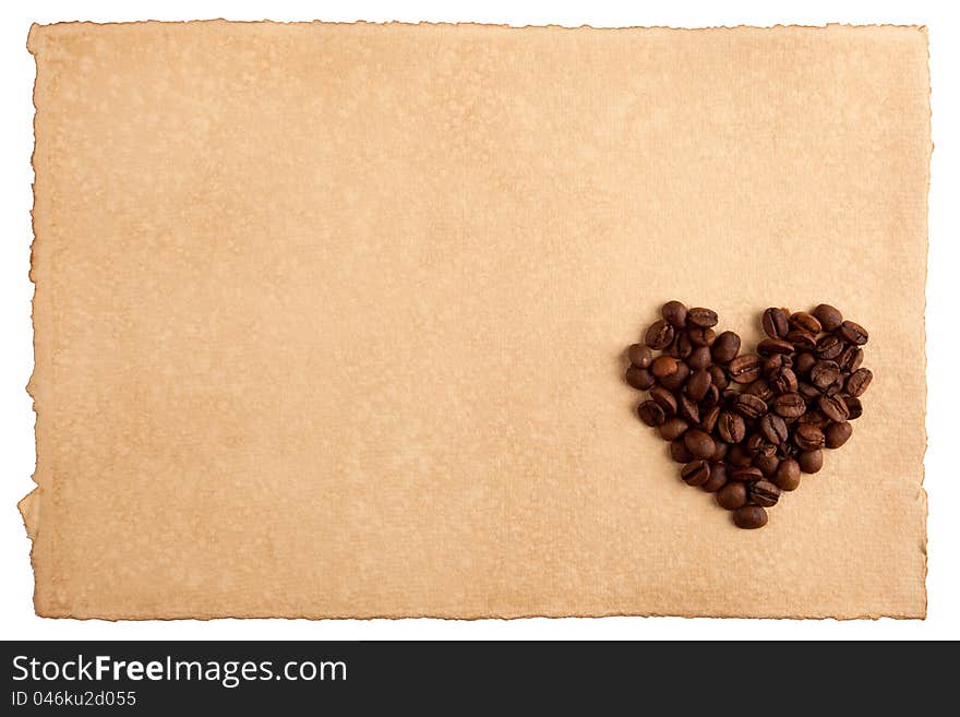 Heart symbol made from coffee crops on hand-made paper and isolated on white. Place for text. Heart symbol made from coffee crops on hand-made paper and isolated on white. Place for text.