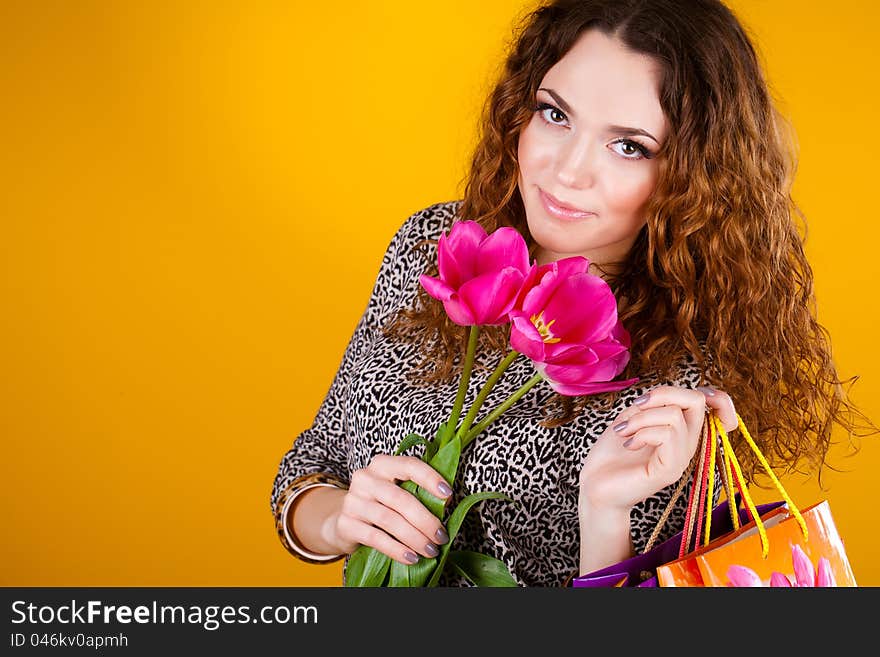 Beautiful woman with flowers and bags long fibers