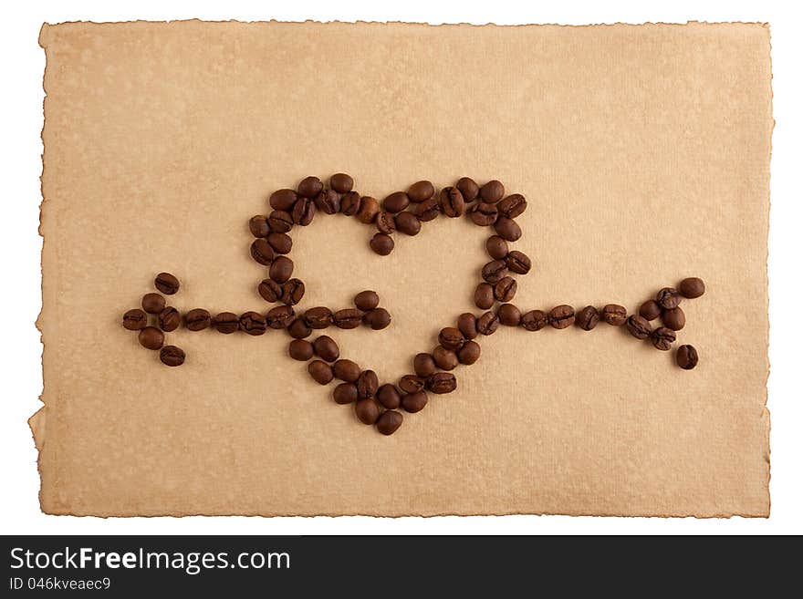 Heart symbol made from coffee crops on hand-made paper and isolated on white. Place for text. Heart symbol made from coffee crops on hand-made paper and isolated on white. Place for text.