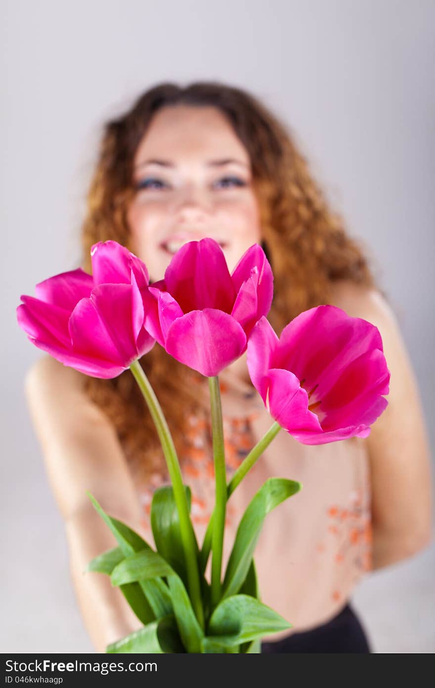 Woman With Red Flowers In The Studio