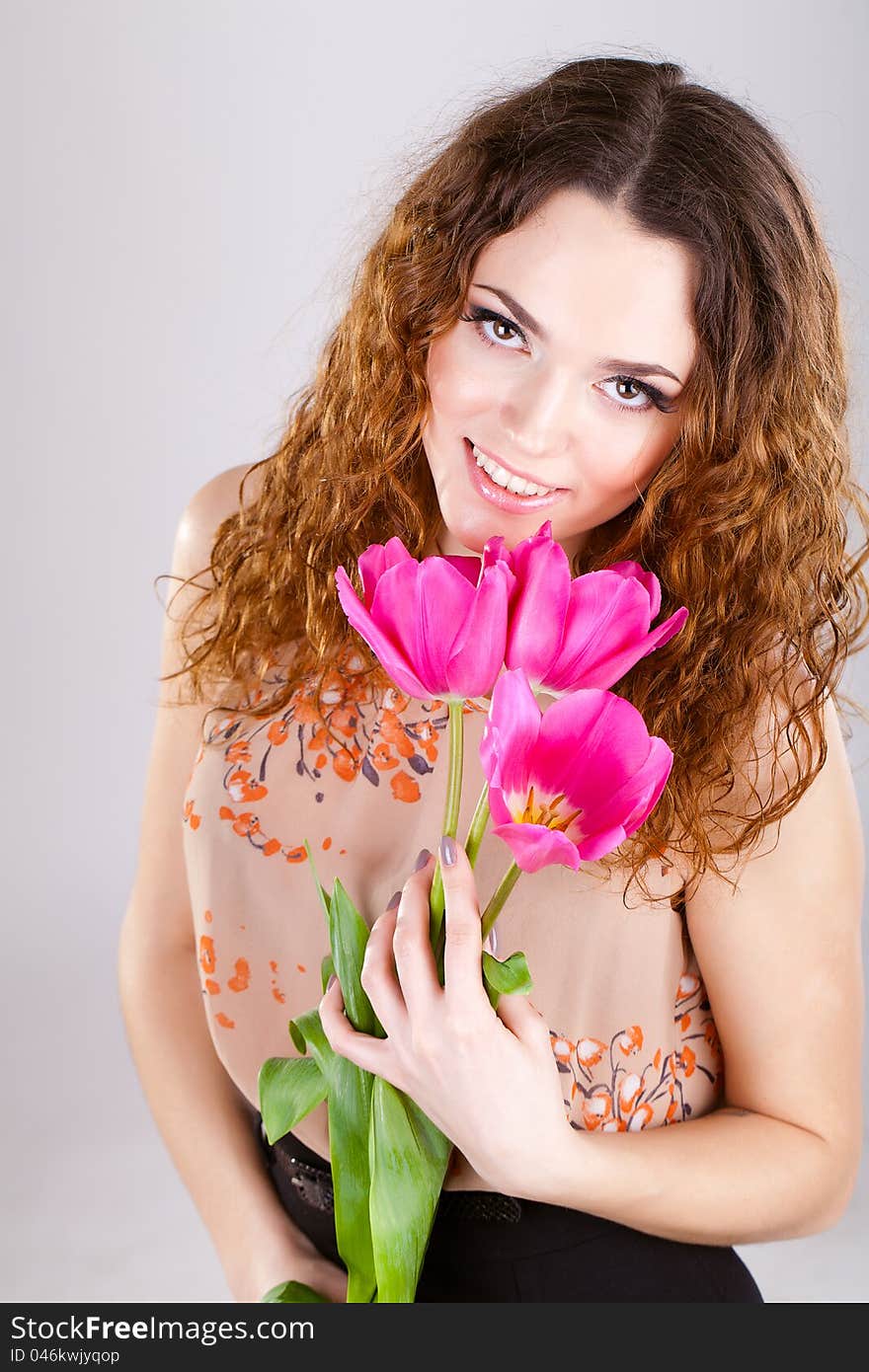 Woman with red flowers in the studio