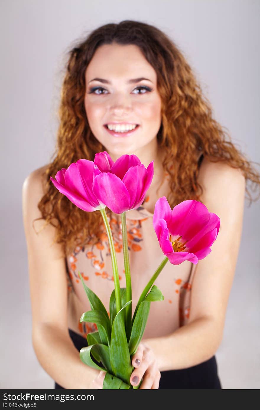 Woman With Red Flowers In The Studio