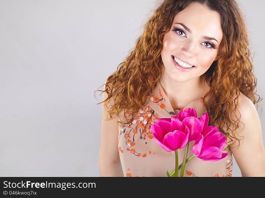 Beautiful woman with flowers in studio. Beautiful woman with flowers in studio