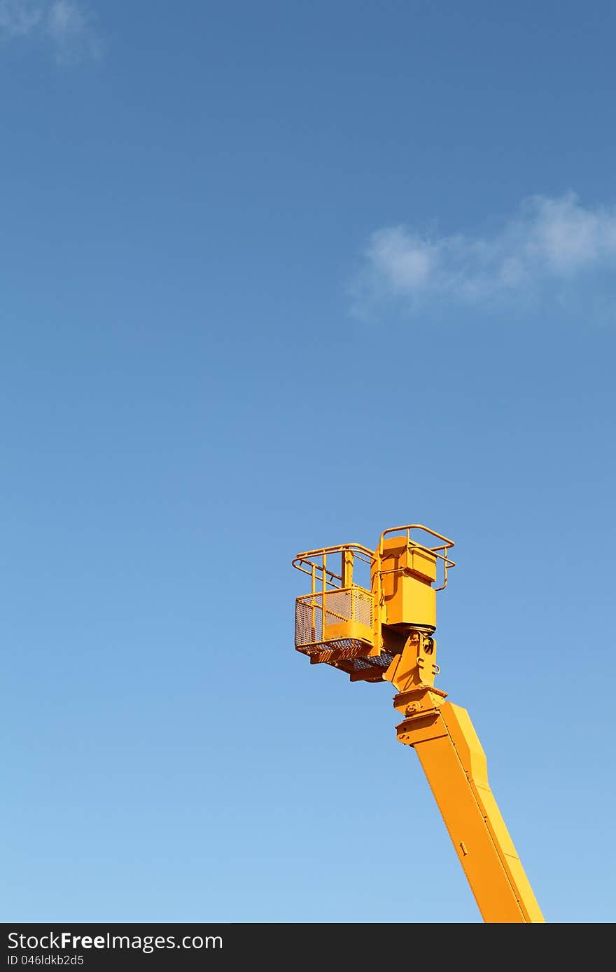 Cherry picker platform against a blue sky