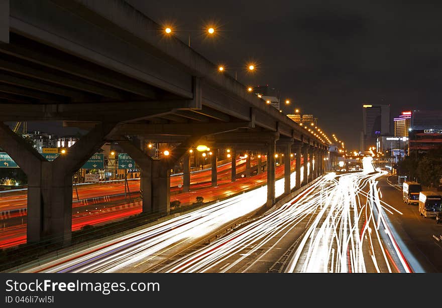 Lights on at night. In the city the car is running. Lights on at night. In the city the car is running.