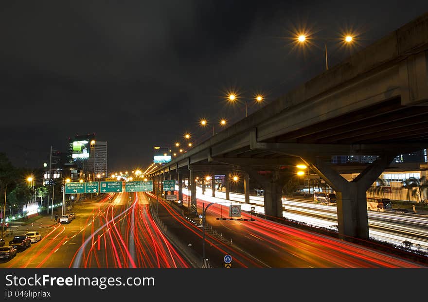 Lights on at night. In the city the car is running. Lights on at night. In the city the car is running.