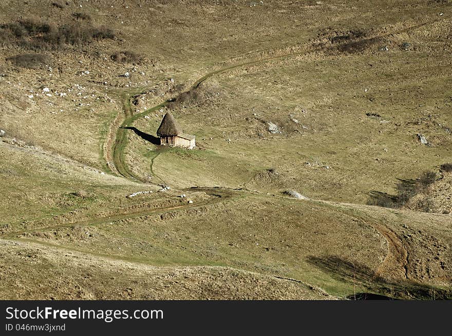 A small barn in the middle of the meadow