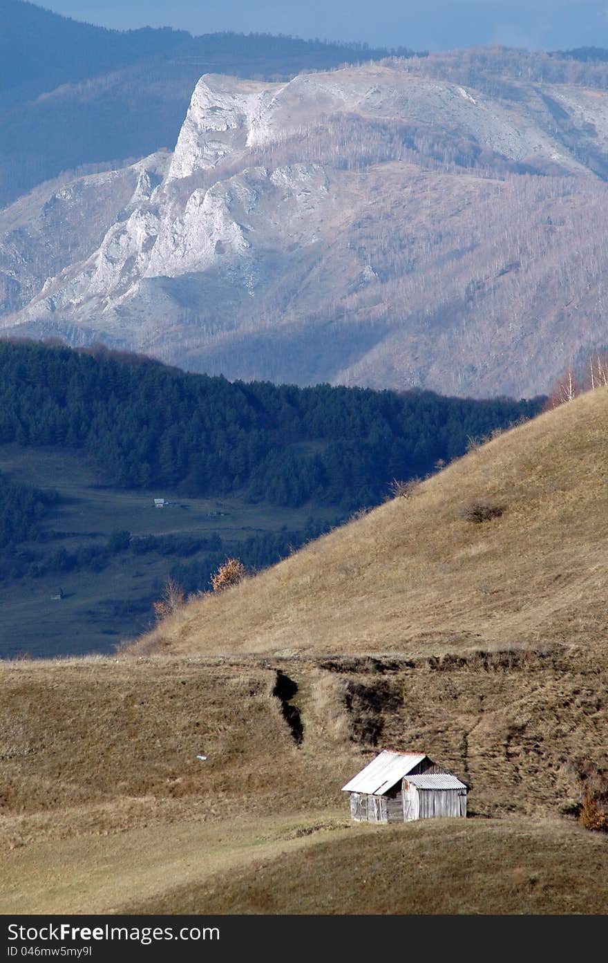 A small barn in the middle of the meadow